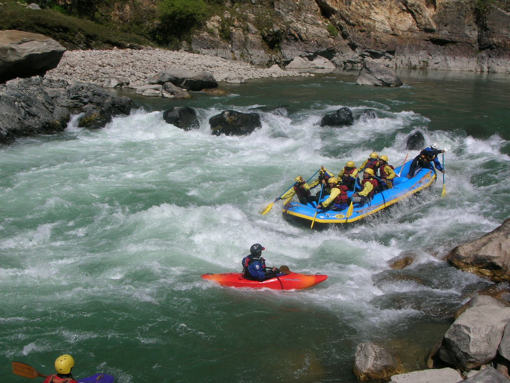 Group white water rafting through rapids