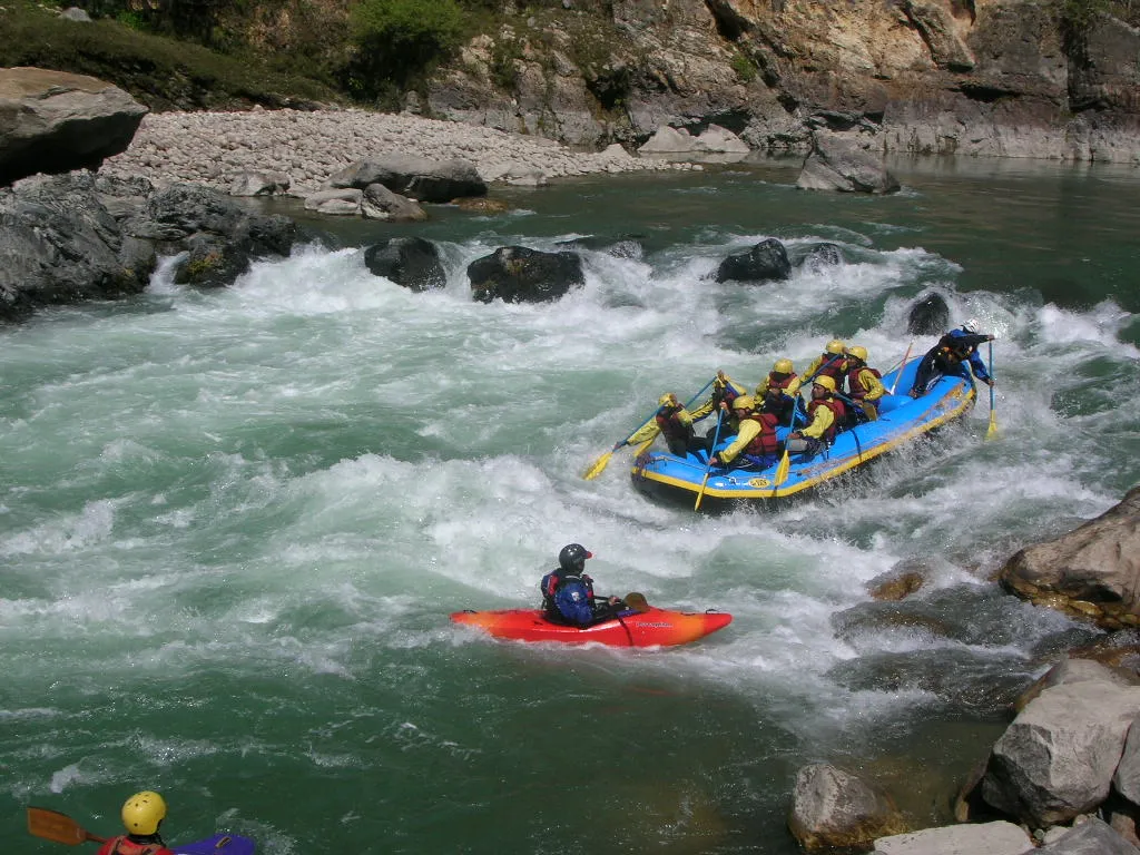 Group white water rafting through rapids